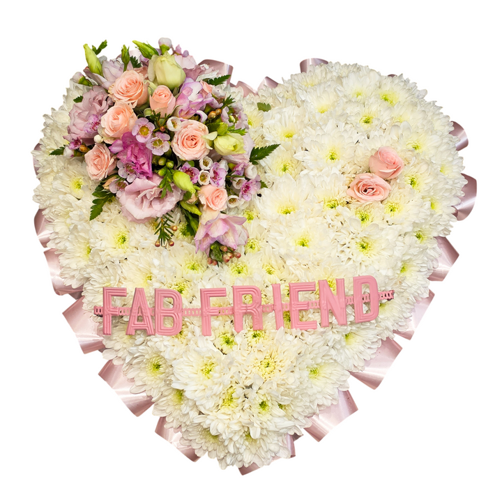 Heart-shaped floral arrangement featuring white chrysanthemums, pink roses, purple and peach carnations, green foliage, and a pink 'FAB FRIEND' sign on a white background.